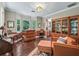 Cozy living room with hardwood floors, a decorative hutch, and natural light at 6577 Nw 193Rd St, Micanopy, FL 32667