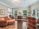 Bright living room featuring hardwood floors, a seating area, and views of the outdoors at 6577 Nw 193Rd St, Micanopy, FL 32667