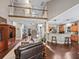 Living area with hardwood floors, vaulted ceiling, open staircase, and eat-in kitchen bar at 6577 Nw 193Rd St, Micanopy, FL 32667