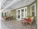 Covered outdoor patio with wicker furniture, ceiling fans, and tiled flooring at 6577 Nw 193Rd St, Micanopy, FL 32667