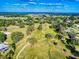 Aerial view of community with winding paths through a green landscape, and scattered residences in the distance at 7787 Nw 56Th Pl, Ocala, FL 34482