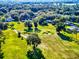 Golf course community, with lush green fairways, mature trees, and well-maintained homes at 7787 Nw 56Th Pl, Ocala, FL 34482