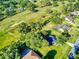 Aerial view of homes in a neighborhood featuring tree-lined streets and green lawns at 7787 Nw 56Th Pl, Ocala, FL 34482