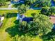 Residential property displaying sprawling, verdant grounds, complete with mature shade trees and a private driveway at 7787 Nw 56Th Pl, Ocala, FL 34482