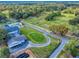 Aerial view showcases the golf course, community pool, and surrounding landscape of the Golden Hills community at 7787 Nw 56Th Pl, Ocala, FL 34482
