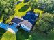 An aerial perspective of a meticulously landscaped property featuring a private driveway and flourishing foliage at 7787 Nw 56Th Pl, Ocala, FL 34482