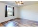 Bedroom with laminate flooring, ceiling fan, and window with black-out curtains at 7787 Nw 56Th Pl, Ocala, FL 34482