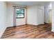 Bedroom with hardwood floors and a window providing natural light and a closet at 7787 Nw 56Th Pl, Ocala, FL 34482