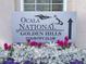 Ocala National at Golden Hills sign with flowers, indicating the entrance to the prestigious golf community at 7787 Nw 56Th Pl, Ocala, FL 34482