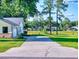 Long driveway leading to a home with mature trees and well-maintained lawns and landscaping at 7787 Nw 56Th Pl, Ocala, FL 34482