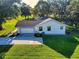Well maintained home with manicured lawn, a paved driveway, and mature trees at 7787 Nw 56Th Pl, Ocala, FL 34482