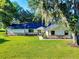 Charming single-story home with lush lawn, brick accents, and beautiful landscaping at 7787 Nw 56Th Pl, Ocala, FL 34482