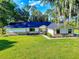 Charming single-story home featuring a well-manicured lawn and mature trees at 7787 Nw 56Th Pl, Ocala, FL 34482