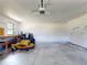 Spacious garage featuring ample room for storage and a riding lawn mower at 7787 Nw 56Th Pl, Ocala, FL 34482
