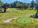 Scenic aerial view of the lush green golf course in the Golden Hills community on a sunny day at 7787 Nw 56Th Pl, Ocala, FL 34482