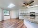 Open kitchen boasting white cabinets, granite countertops, and stainless steel appliances at 7787 Nw 56Th Pl, Ocala, FL 34482