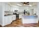 Bright kitchen featuring stainless steel appliances, granite countertops, and white cabinetry at 7787 Nw 56Th Pl, Ocala, FL 34482