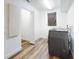 Bright laundry room with gray front load washer and dryer, and wood floors at 7787 Nw 56Th Pl, Ocala, FL 34482