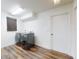 Bright laundry room with gray front load washer and dryer, and wood floors at 7787 Nw 56Th Pl, Ocala, FL 34482