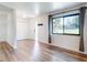Bright living room with wood floors, a large window, and neutral paint at 7787 Nw 56Th Pl, Ocala, FL 34482