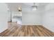 Open-concept living room with hardwood floors and modern lighting at 7787 Nw 56Th Pl, Ocala, FL 34482