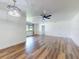 Bright living room featuring wood floors, a ceiling fan, and a modern light fixture at 7787 Nw 56Th Pl, Ocala, FL 34482