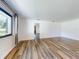 Spacious living room with wood floors, neutral paint, and lots of natural light at 7787 Nw 56Th Pl, Ocala, FL 34482