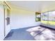Screened porch featuring carpet, and a view of the yard at 7787 Nw 56Th Pl, Ocala, FL 34482