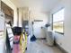 A utility room featuring essential appliances, a water softener and natural light at 7787 Nw 56Th Pl, Ocala, FL 34482