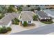 Aerial view of a home with well-maintained landscaping and surrounding neighborhood at 882 Tanglewood Pl, The Villages, FL 32162