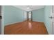 This bedroom offers natural light, wood flooring, and a ceiling fan at 882 Tanglewood Pl, The Villages, FL 32162