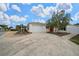 Charming home with a well-manicured yard, palm trees, and a welcoming driveway at 882 Tanglewood Pl, The Villages, FL 32162