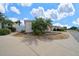 Landscaped front yard with palm trees, decorative rock, and a well-maintained lawn at 882 Tanglewood Pl, The Villages, FL 32162
