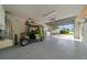 Spacious garage with a golf cart, and laundry area featuring washer and dryer at 882 Tanglewood Pl, The Villages, FL 32162