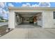An open garage features storage, a laundry area, and golf cart, providing functional space at 882 Tanglewood Pl, The Villages, FL 32162