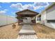 Backyard gazebo surrounded by gravel, with a wooden walkway and fenced yard at 882 Tanglewood Pl, The Villages, FL 32162