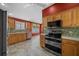 Kitchen featuring stainless steel oven and microwave with light wood cabinets at 882 Tanglewood Pl, The Villages, FL 32162