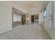 Screened-in lanai with tile floor, ceiling fan, sliding doors, and bar cabinet at 882 Tanglewood Pl, The Villages, FL 32162