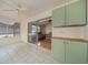 Enclosed lanai with ceiling fan, sliding glass door to the living room, and neutral tile floors at 882 Tanglewood Pl, The Villages, FL 32162