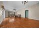Spacious living room with hardwood floors, fan, and lots of natural light at 882 Tanglewood Pl, The Villages, FL 32162