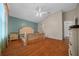 Bright main bedroom with hardwood floors, fan, and lots of natural light at 882 Tanglewood Pl, The Villages, FL 32162