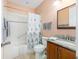 Hall bathroom features a shower with tub, wood vanity and tiled floor at 9728 Sw 95Th Loop, Ocala, FL 34481