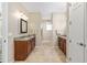 Elegant bathroom featuring dual vanities with granite countertops and ample cabinet space at 9728 Sw 95Th Loop, Ocala, FL 34481