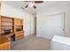 Bedroom with carpet flooring, ceiling fan and a closet at 9728 Sw 95Th Loop, Ocala, FL 34481