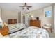 Comfortable bedroom featuring two beds, dressers, and a window for natural light at 9728 Sw 95Th Loop, Ocala, FL 34481