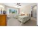 Bright bedroom with two beds, a large window, and carpet flooring at 9728 Sw 95Th Loop, Ocala, FL 34481