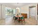 Dining area with sliding glass doors to patio, chandelier, and ample natural light at 9728 Sw 95Th Loop, Ocala, FL 34481