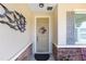 Charming front entrance with stone accents, decorative wreath, and inviting curb appeal at 9728 Sw 95Th Loop, Ocala, FL 34481