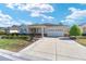 Attractive home boasts a pristine lawn, stone accents, and a driveway leading to the garage at 9728 Sw 95Th Loop, Ocala, FL 34481