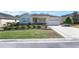 Inviting single-Gathering home with manicured landscaping, stone accents, and attached two-car garage at 9728 Sw 95Th Loop, Ocala, FL 34481